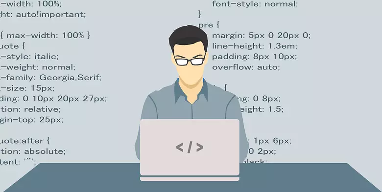 Programmer sitting at a laptop with a backdrop of CSS code