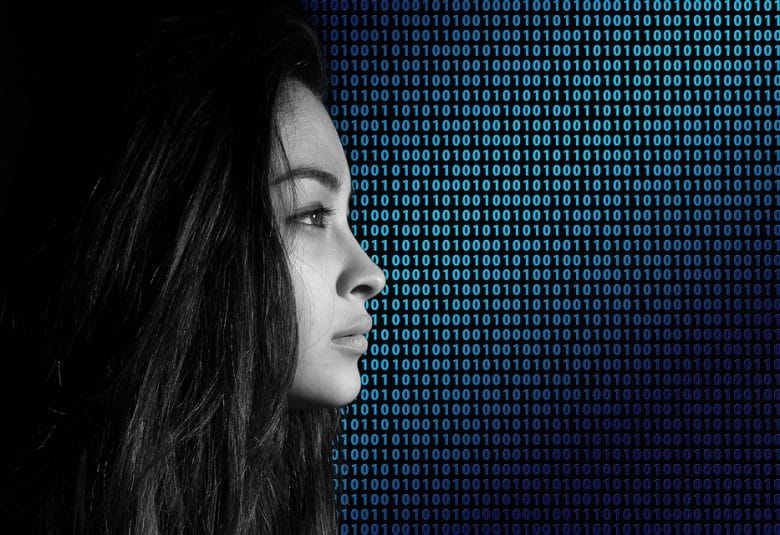 woman standing in front of binary code