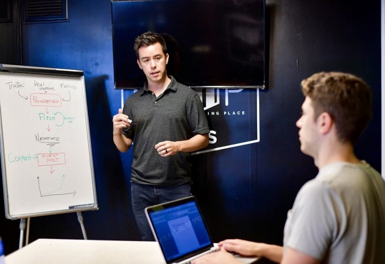 Man standing in front of whiteboard teaching content writing