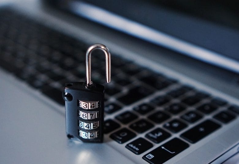 padlock sitting on a laptop keyboard