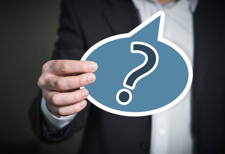 Man holding a question mark