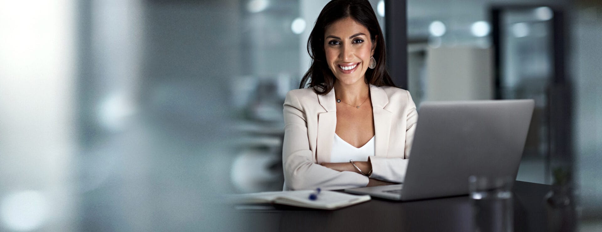 Professional woman at a desk representing Webmaster Plans and WordPress Hosting services in Charlottesville, VA.